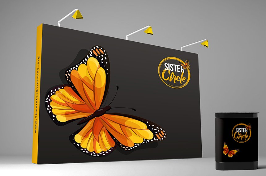 Black 20-ft trade-show back wall with orange monarch butterfly, Sister Circle logo, and matching podium, designed by Rahat Abir.